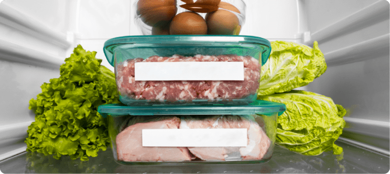 Fresh mesh and veg inside a fridge, demostrating food hygiene.